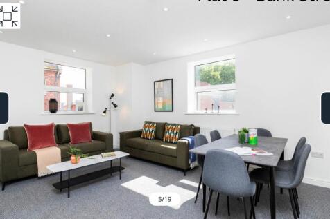 A spacious and inviting modern living room, per...
