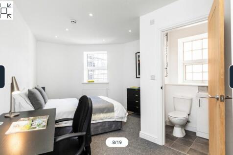 A spacious and bright double bedroom featuring ...