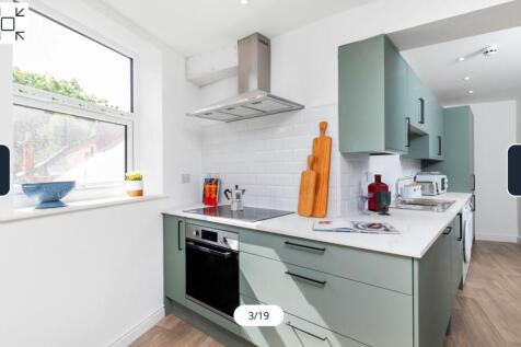 A modern and well-lit kitchenette featuring sty...