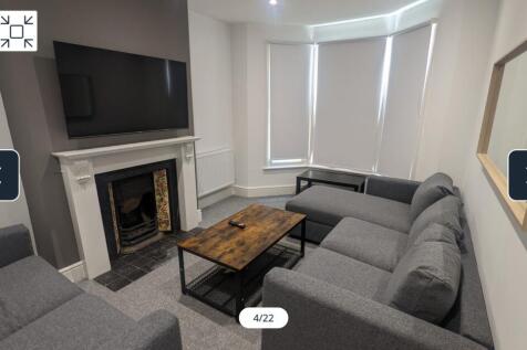 A spacious and inviting modern living room, per...