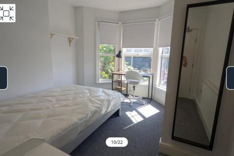 A bright and spacious double bedroom featuring ...