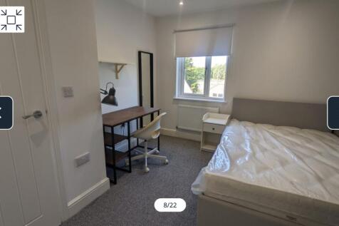 A bright and spacious double bedroom with moder...