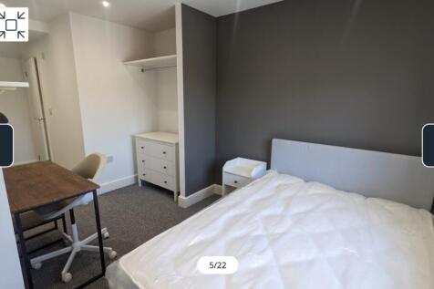 A spacious and well-lit double bedroom featurin...