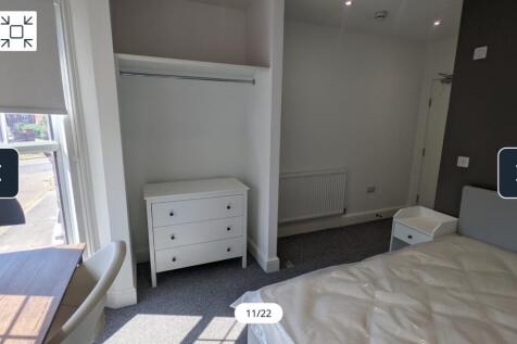 A bright and spacious double bedroom with moder...