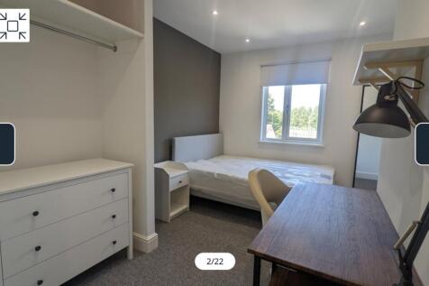 A spacious and well-lit double bedroom featurin...
