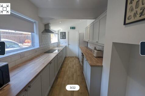 A spacious and modern kitchen featuring ample c...