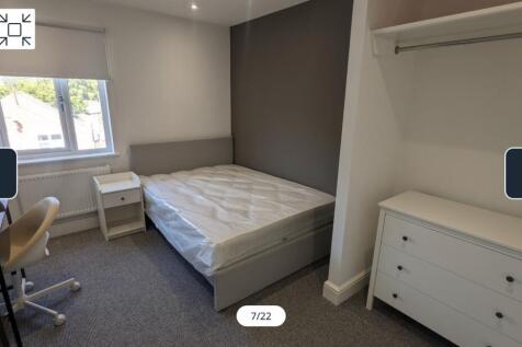 A spacious and well-lit double bedroom featurin...