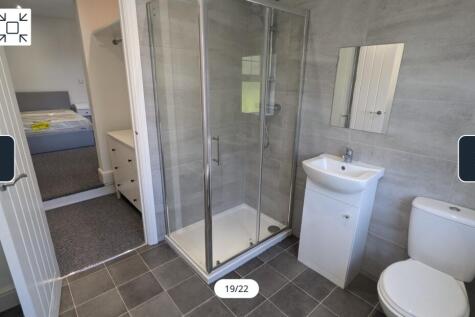 A modern and spotless bathroom featuring a spac...