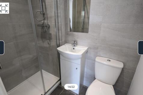 A modern and tidy bathroom featuring a sleek sh...