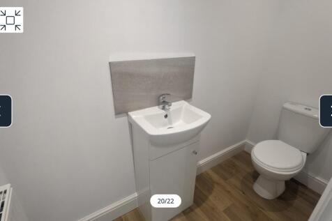 A clean and modern single toilet, featuring a s...