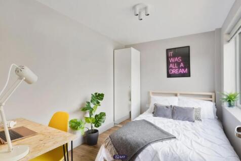 A bright and inviting double bedroom featuring ...