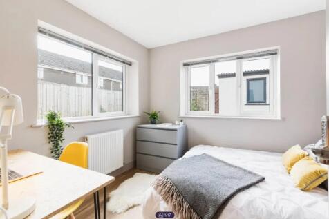 A bright and spacious double bedroom with large...