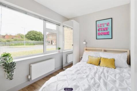 A bright and cozy double bedroom featuring larg...