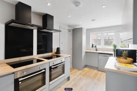 A modern and bright kitchen featuring sleek app...