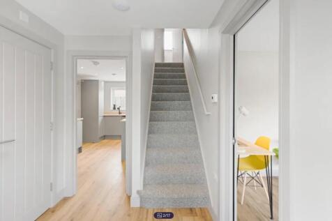 A bright and clean hallway leading to various r...