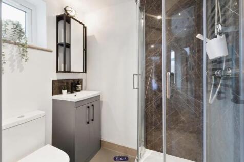 A modern and stylish bathroom featuring a sleek...