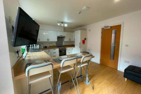 A modern and spacious kitchenette with ample na...