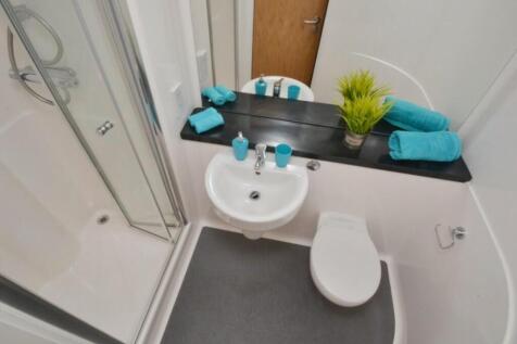 A modern and tidy bathroom featuring a sleek de...