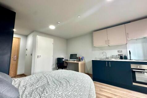 A spacious and modern double bedroom featuring ...
