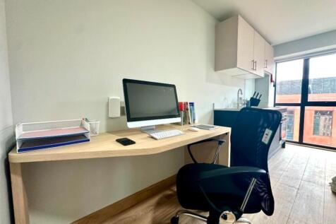 A bright and tidy communal workspace featuring ...