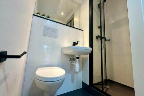 A modern and clean bathroom with a sleek design...