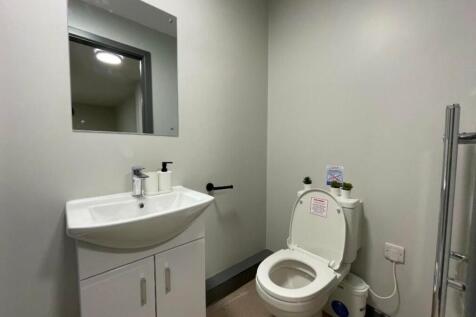 A clean and modern single toilet with stylish f...