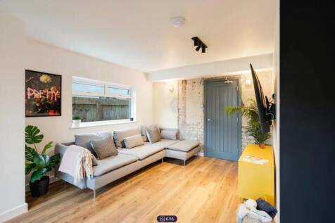 A spacious and stylish modern living room featu...