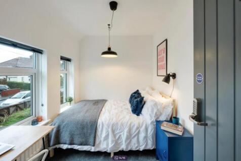 A bright and inviting double bedroom featuring ...