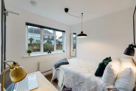 A bright and inviting double bedroom featuring ...