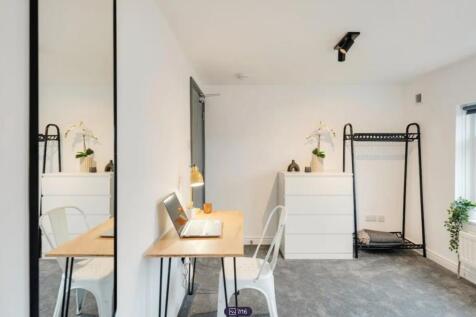 A bright and stylish double bedroom featuring a...