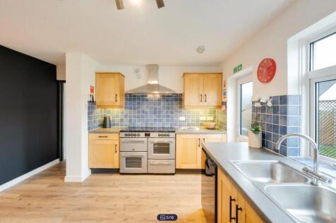A spacious and modern kitchen with ample natura...