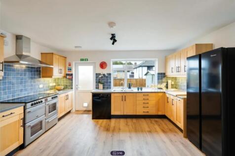 A spacious and modern kitchen with ample natura...