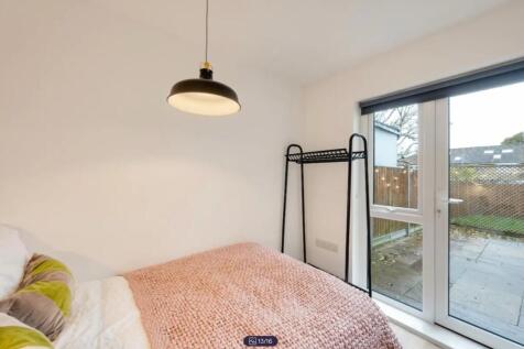 A bright and inviting double bedroom featuring ...