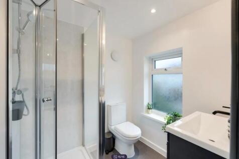 A modern and stylish bathroom featuring a sleek...