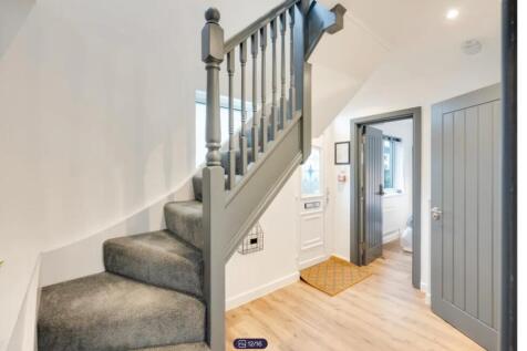 A bright and clean staircase leading to upper l...