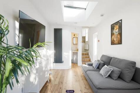 A bright and spacious modern living room featur...