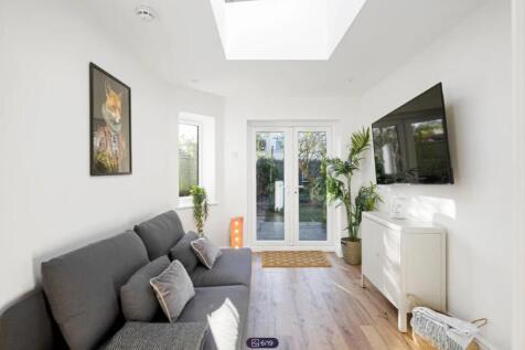 A spacious and bright modern living room with a...
