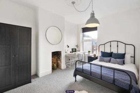 A bright and stylish double bedroom featuring a...