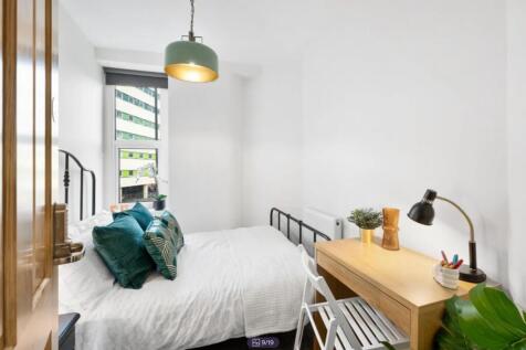A bright and inviting double bedroom featuring ...