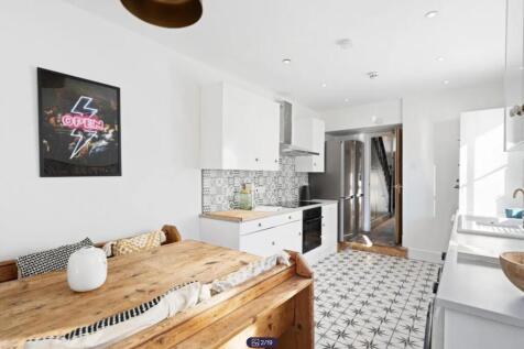 A bright and modern kitchen featuring stylish d...