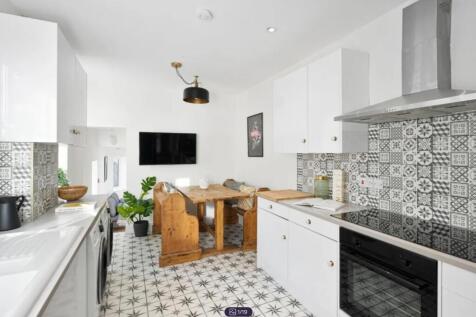 A stylish and modern kitchen featuring ample sp...