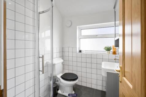 A modern and bright bathroom featuring a spacio...