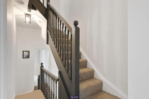 A well-maintained staircase with stylish railin...