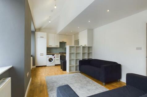 A spacious and modern living room with ample na...
