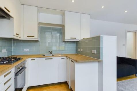 A modern kitchenette featuring sleek cabinetry ...