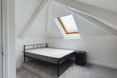 A bright and spacious double bedroom with moder...