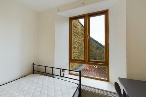 A bright and inviting double bedroom with large...