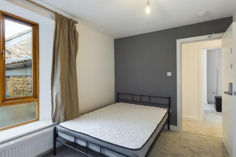 A bright and spacious double bedroom featuring ...