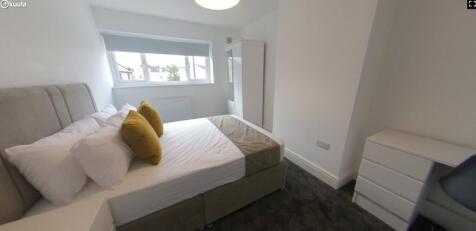 A bright and stylish double bedroom featuring m...
