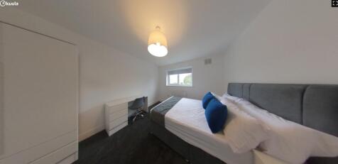 A bright and inviting double bedroom featuring ...